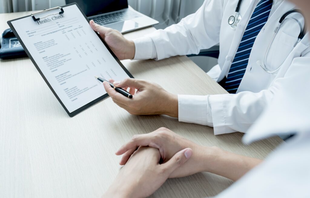 Doctor write report and explained health examination results to the patient, medical checkup concept